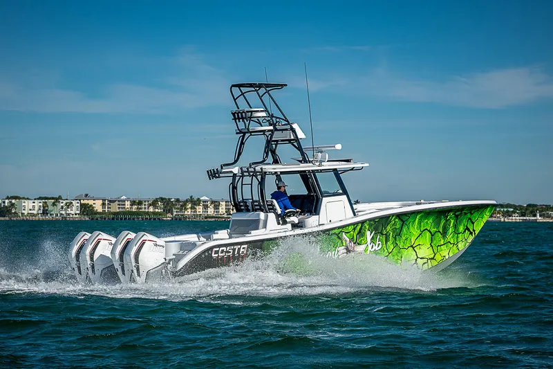 Slide: The Image of 2024 Costa Custom Boats 34 cruising on water with vibrant green hull design. - 27