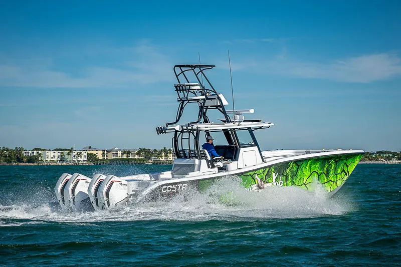 Slide: The Image of 2024 Costa Custom Boats 34 cruising on water with vibrant green hull design. - 29