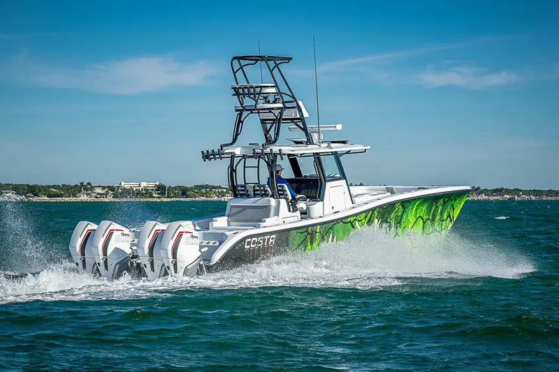 Slide: The Image of 2024 Costa Custom Boats 34 cruising on open water with vibrant green hull design. - 30