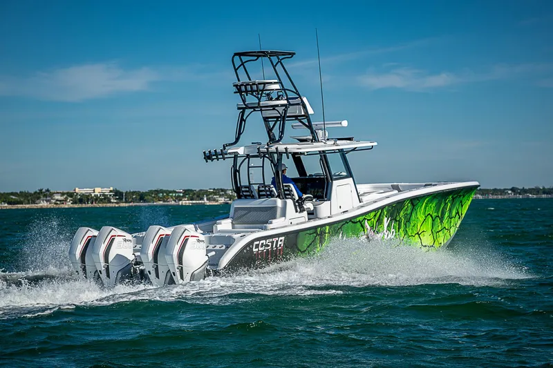 Slide: The Image of 2024 Costa Custom Boats 34 cruising on water with vibrant green hull design. - 31