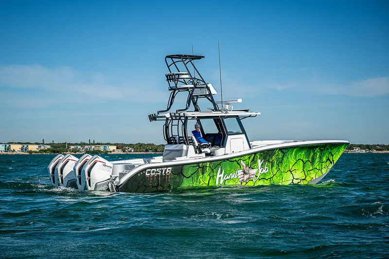 Slide: The Image of 2024 Costa Custom Boats 34 with vibrant green hull design cruising on open water. - 32