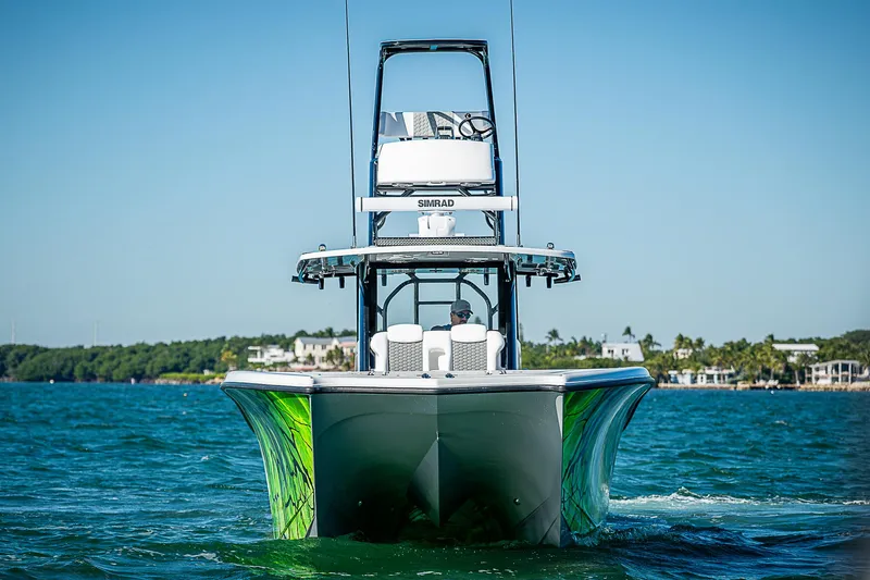 Slide: The Image of 2024 Costa Custom Boats 34 on water, vibrant green accents, clear blue sky. - 34