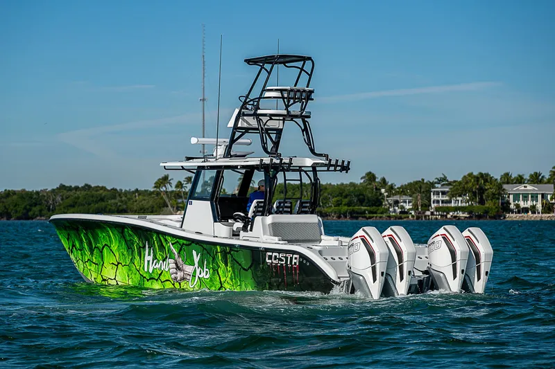 Slide: The Image of 2024 Costa Custom Boats 34 with vibrant green hull design on the water. - 42