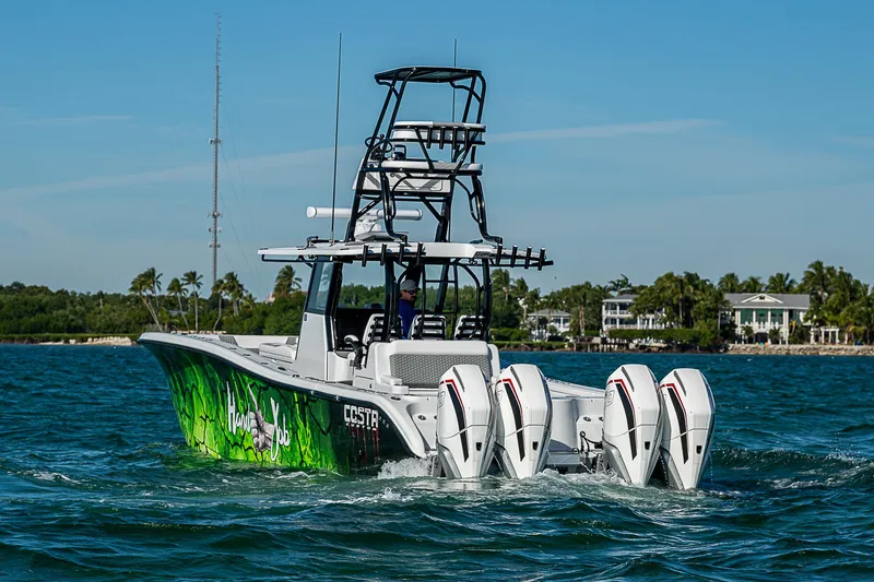 Slide: The Image of 2024 Costa Custom Boats 34 with vibrant design and multiple engines on the water. - 43