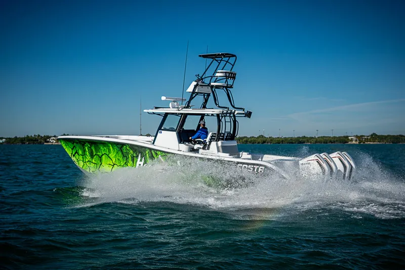 Slide: The Image of 2024 Costa Custom Boats 34 cruising on open water, vibrant green hull design. - 6