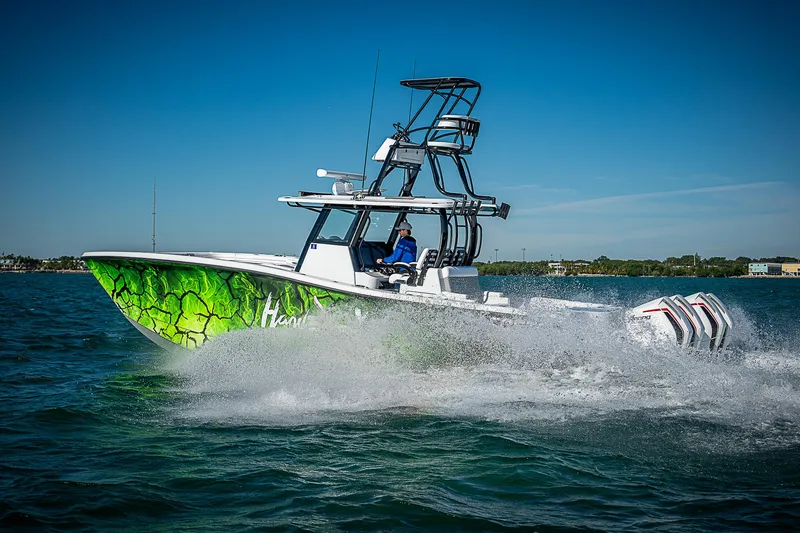 Slide: The Image of 2024 Costa Custom Boats 34 cruising on water with vibrant green hull design. - 8
