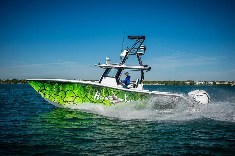 Slide: The Image of 2024 Costa Custom Boats 34 cruising on water with vibrant green hull design. - 9