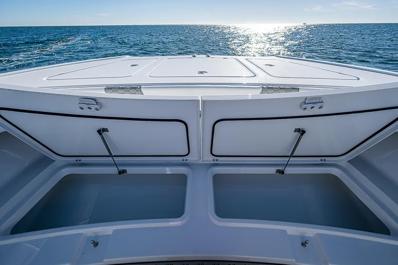 Slide: The Image of 2024 Costa Custom Boats 34 cruising on water near luxury waterfront homes. - 101