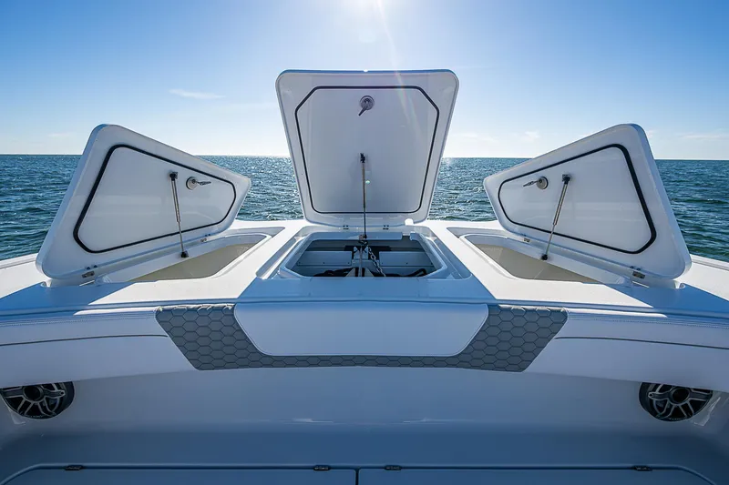 Slide: The Image of 2024 Costa Custom Boats 34 cruising on water near modern buildings. - 102