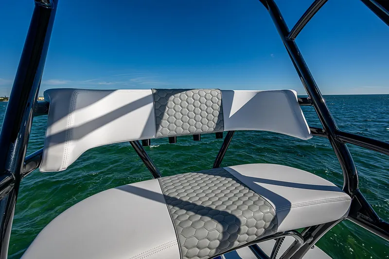 Slide: The Image of 2024 Costa Custom Boats 34 cruising on a scenic waterway under a clear blue sky. - 62