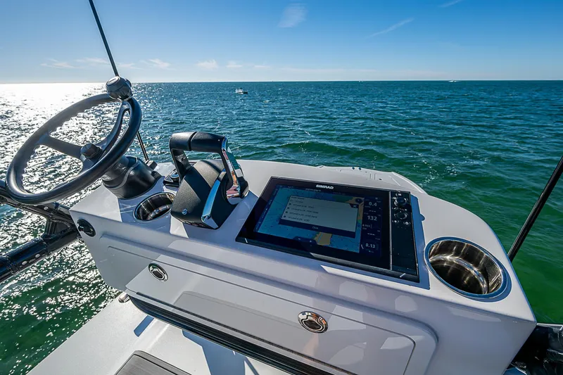 Slide: The Image of 2024 Costa Custom Boats 34 cruising on a scenic waterway with lush greenery. - 63