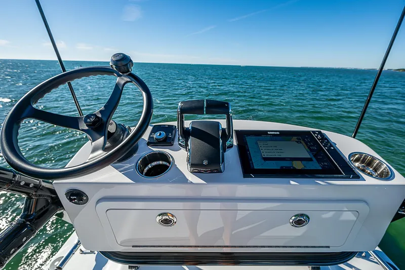 Slide: The Image of 2024 Costa Custom Boats 34 with multiple engines cruising on a scenic waterway. - 65