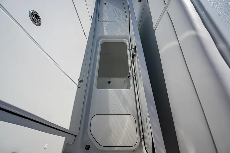 Slide: The Image of 2024 Costa Custom Boats 34 cruising under a bridge, surrounded by lush greenery. - 68