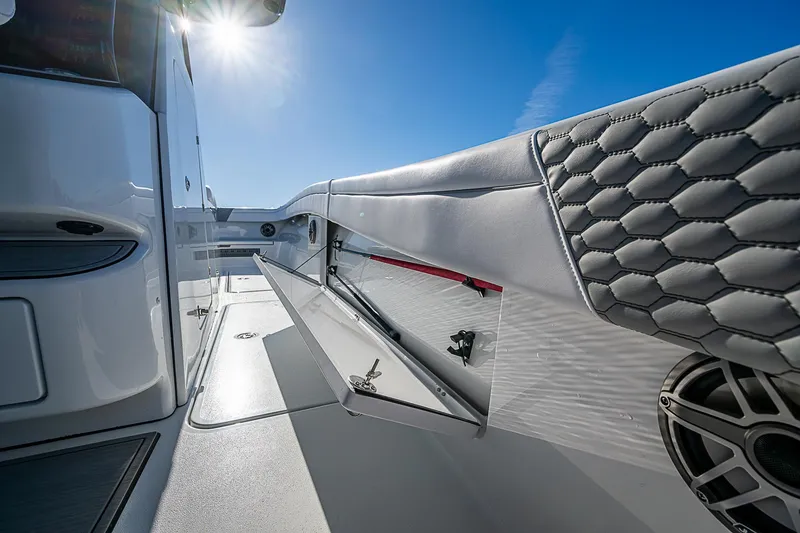 Slide: The Image of 2024 Costa Custom Boats 34 cruising on water near palm trees and buildings. - 70