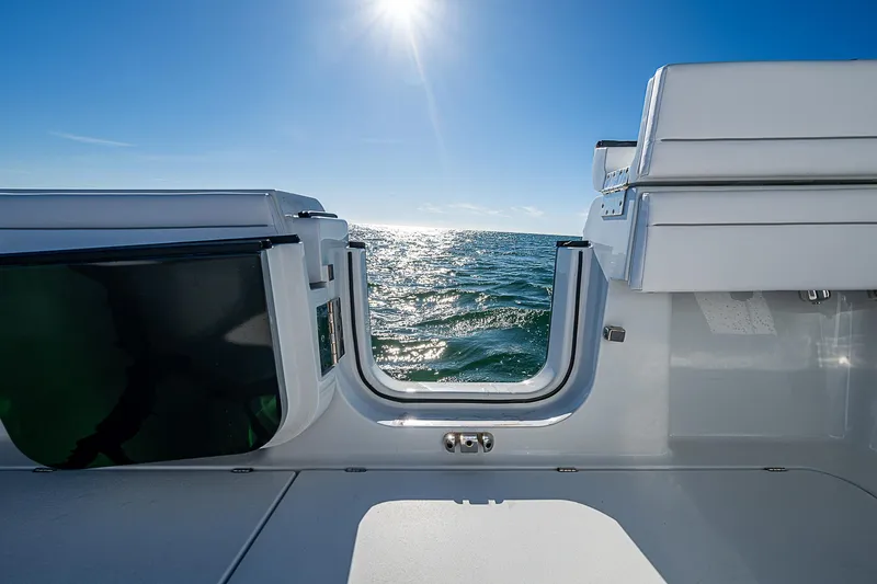 Slide: The Image of 2024 Costa Custom Boats 34 cruising on water near waterfront buildings. - 71