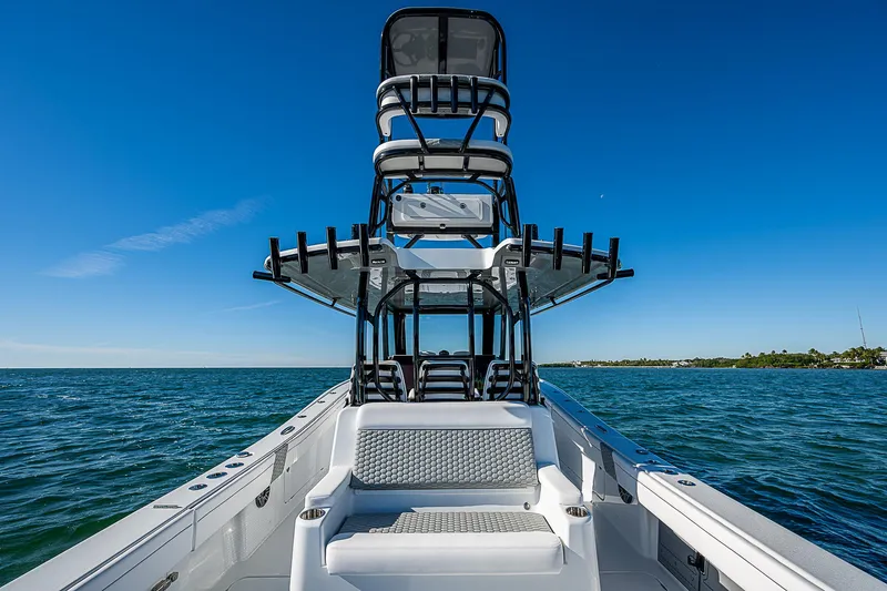 Slide: The Image of 2024 Costa Custom Boats 34 cruising on water near waterfront buildings. - 78