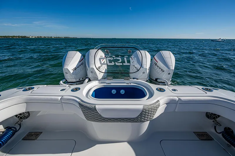 Slide: The Image of 2024 Costa Custom Boats 34 cruising through water near urban waterfront. - 81