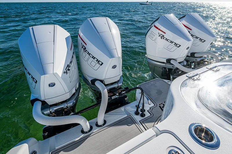 Slide: The Image of 2024 Costa Custom Boats 34 cruising on a scenic waterway with lush greenery. - 83