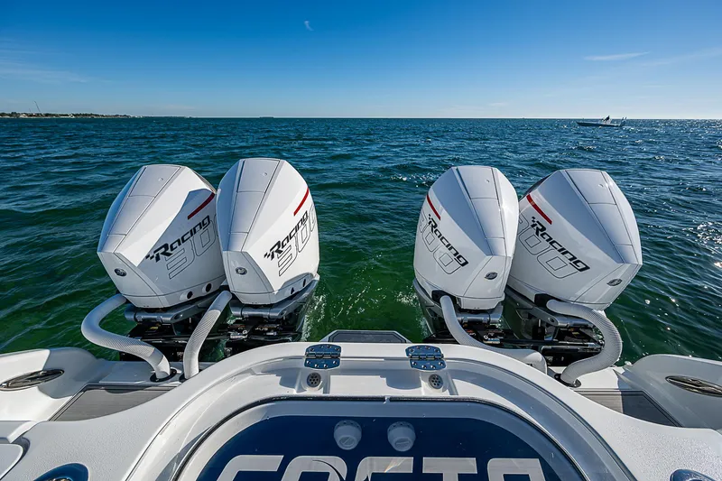 Slide: The Image of 2024 Costa Custom Boats 34 cruising on water near palm trees and buildings. - 84