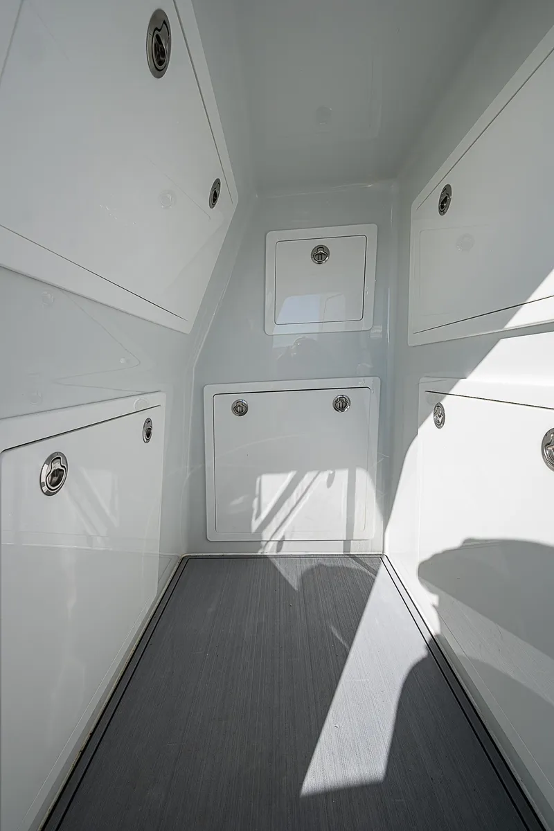 Slide: The Image of 2024 Costa Custom Boats 34 cruising with splashing water near modern waterfront home. - 89