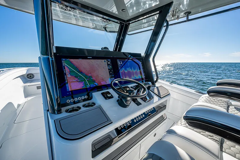 Slide: The Image of 2024 Costa Custom Boats 34 cruising on water near waterfront homes. - 91