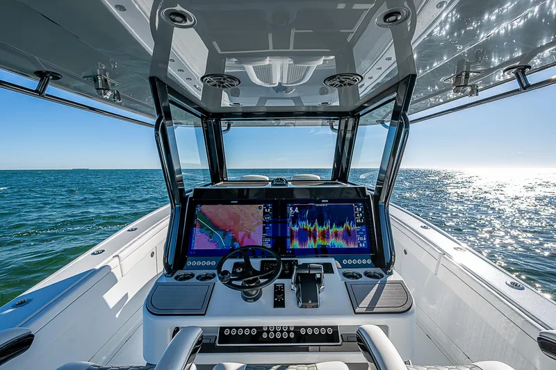 Slide: The Image of 2024 Costa Custom Boats 34 cruising on water near waterfront homes. - 92