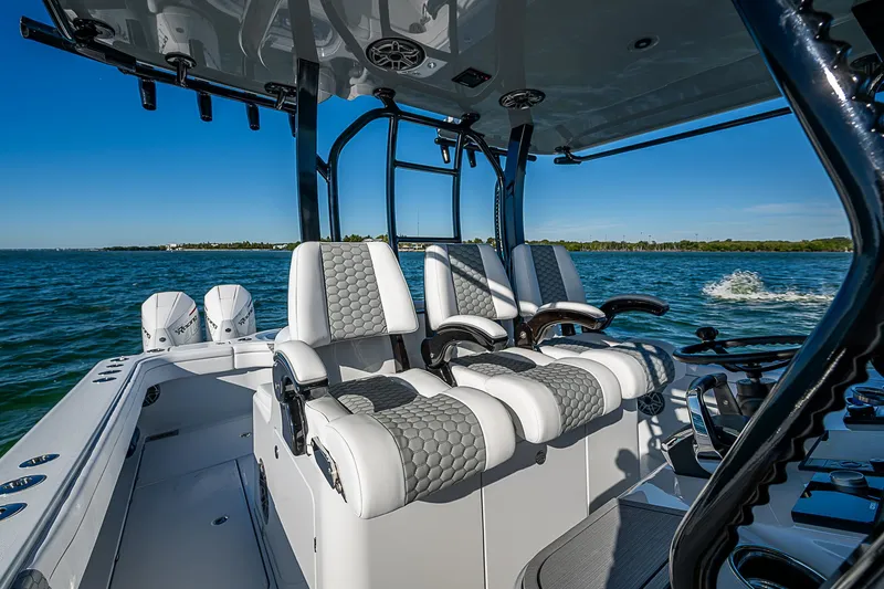 Slide: The Image of 2024 Costa Custom Boats 34 cruising on water near luxury waterfront homes. - 93