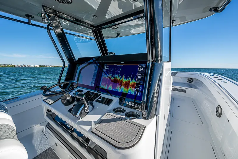 Slide: The Image of 2024 Costa Custom Boats 34 cruising near waterfront buildings and palm trees. - 94