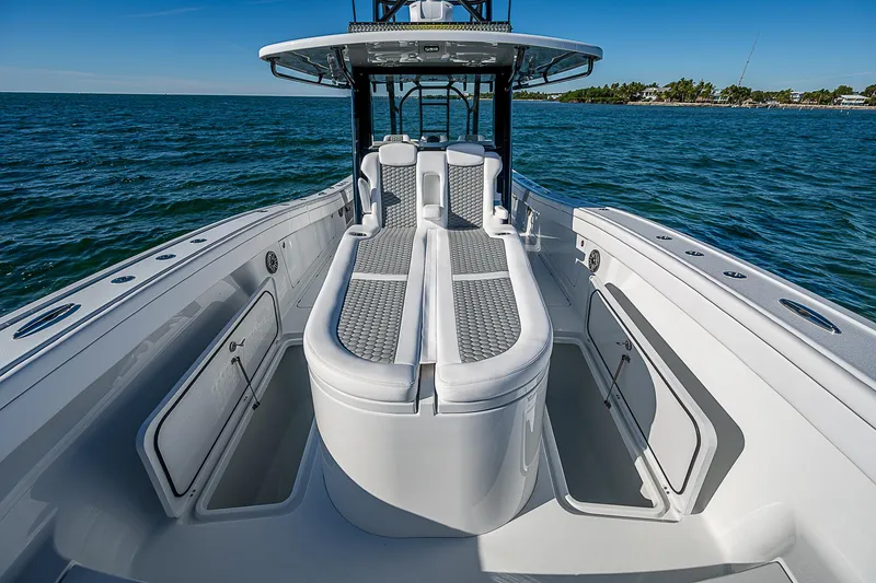 Slide: The Image of 2024 Costa Custom Boats 34 cruising on water near urban skyline. - 96