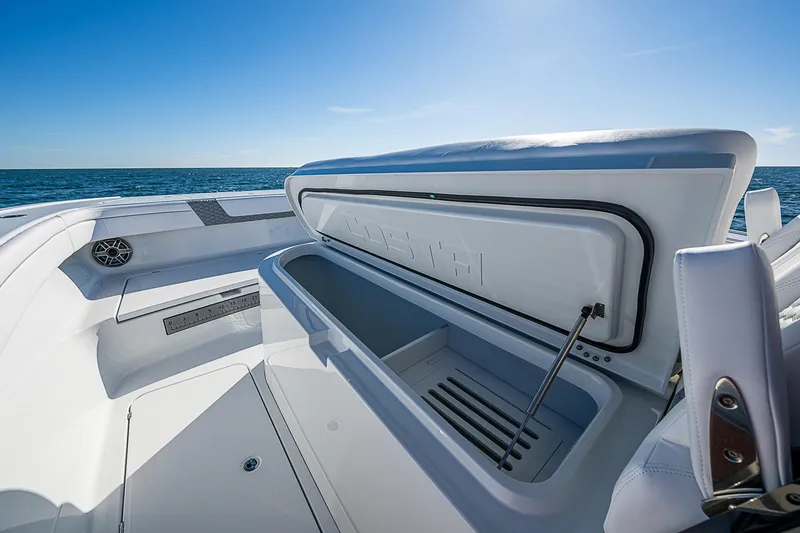 Slide: The Image of 2024 Costa Custom Boats 34 cruising on water near buildings and trees. - 97