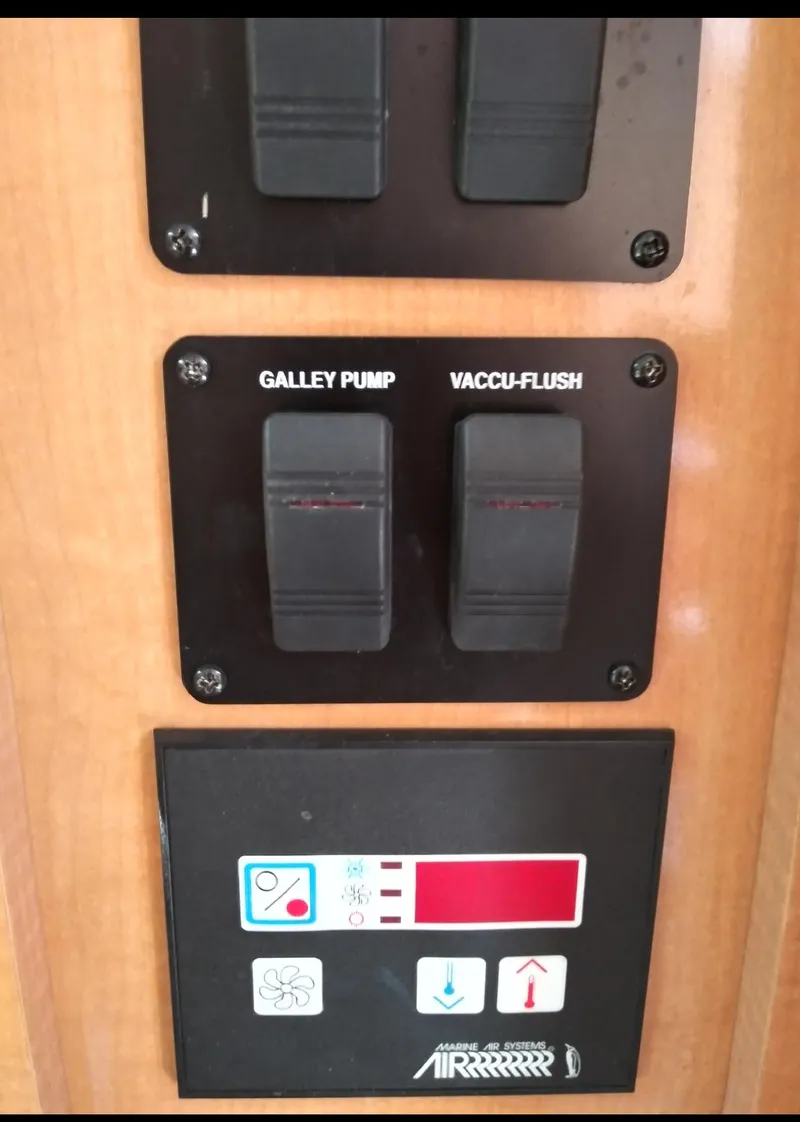 Slide: The Image of Control panel of a 2009 Rinker 260 Express Cruiser with galley pump and vacu-flush switches. - 6