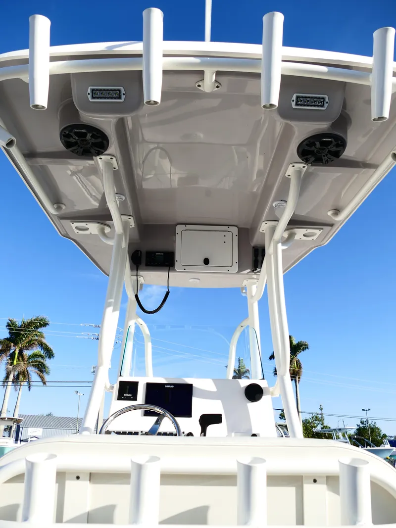 Slide: The Image of 2019 Sea Born LX22 Center Console boat with T-top and electronics, under clear blue sky. - 11