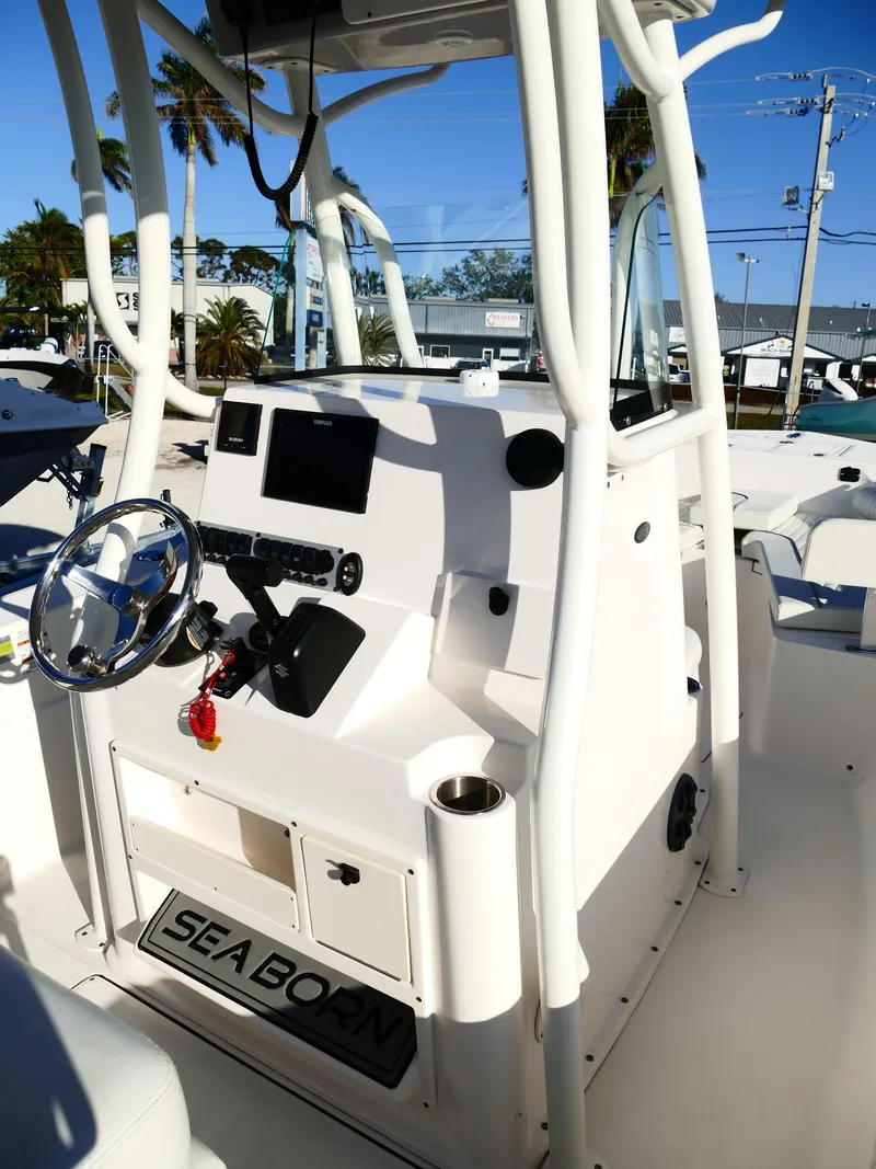 Slide: The Image of 2019 Sea Born LX22 Center Console boat interior with steering wheel and controls. - 12