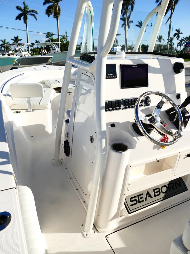 Slide: The Image of 2019 Sea Born LX22 Center Console boat with steering wheel and navigation system. - 13