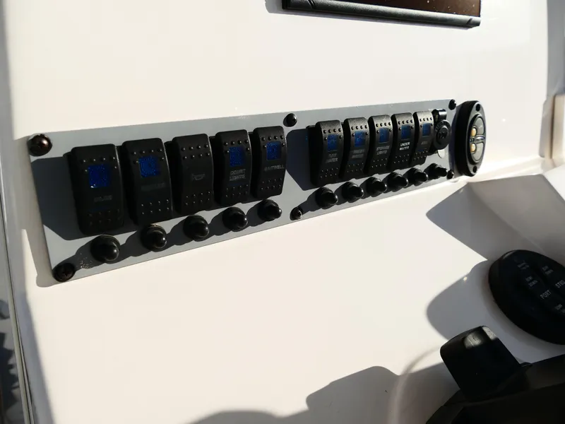 Slide: The Image of Control panel of 2019 Sea Born LX22 Center Console boat with switches and dials. - 14