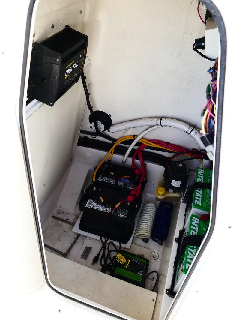 Slide: The Image of 2019 Sea Born LX22 Center Console boat interior with battery and wiring components. - 19