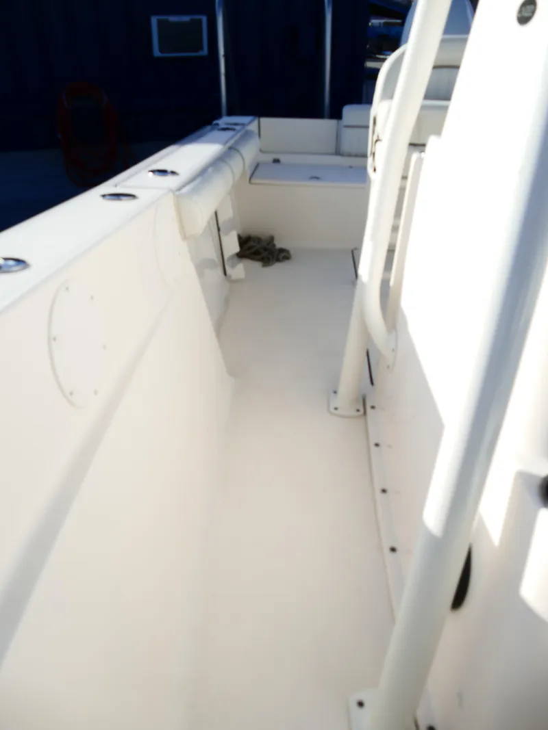 Slide: The Image of 2019 Sea Born LX22 Center Console boat interior, white deck and seating area. - 28