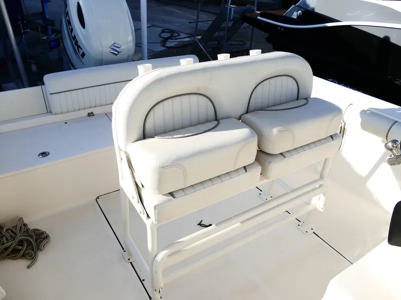 Slide: The Image of 2019 Sea Born LX22 Center Console boat seating area with white cushioned seats. - 31