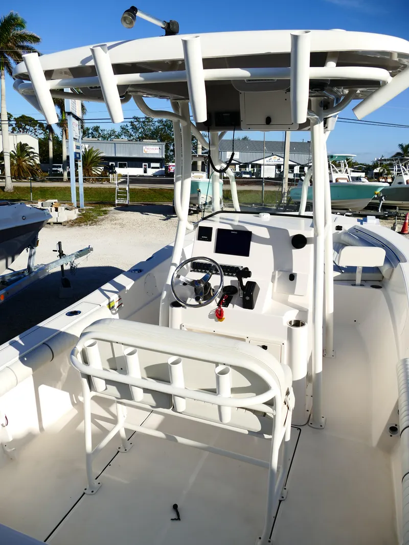 Slide: The Image of 2019 Sea Born LX22 Center Console boat with T-top and modern helm controls. - 7