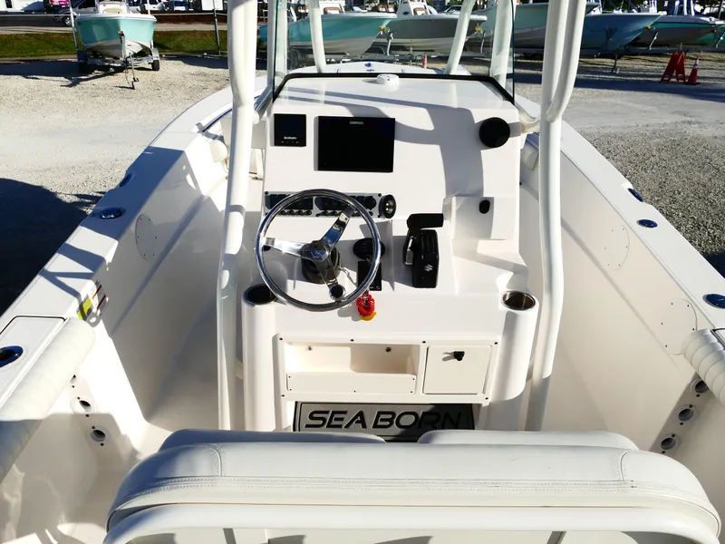 Slide: The Image of 2019 Sea Born LX22 Center Console boat interior with steering wheel and controls. - 8