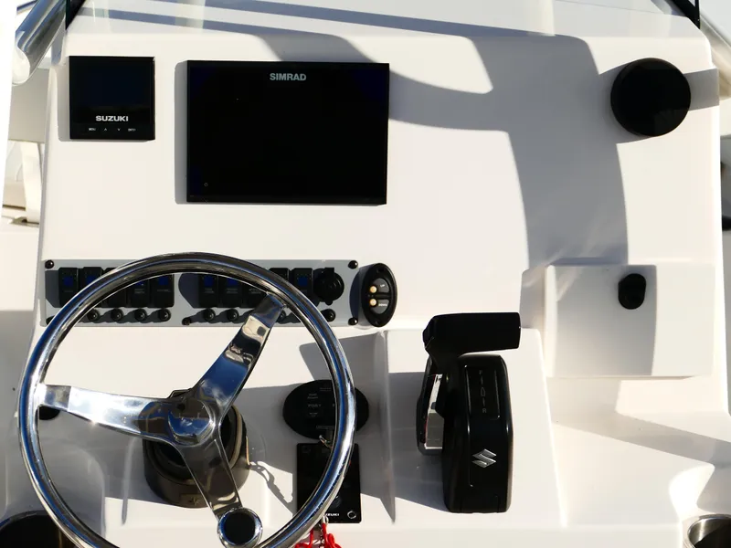 Slide: The Image of 2019 Sea Born LX22 Center Console dashboard with steering wheel and controls. - 9