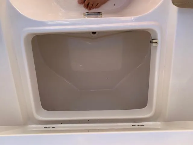 Slide: The Image of Open storage compartment on a 2018 Key West 239 DFS boat. - 12
