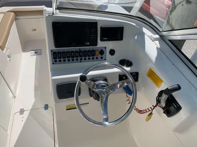 Slide: The Image of 2018 Key West 239 DFS boat dashboard with steering wheel and control panel. - 18