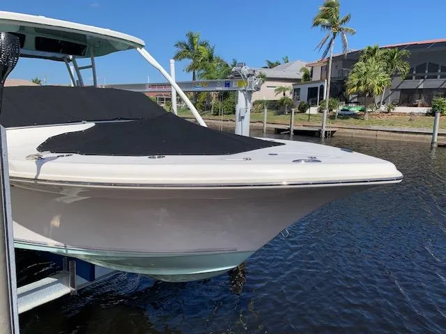 Slide: The Image of 2018 Key West 239 DFS boat docked by waterfront homes, covered and ready for use. - 2