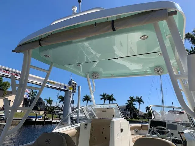 Slide: The Image of 2018 Key West 239 DFS boat with canopy, docked in sunny marina. - 21
