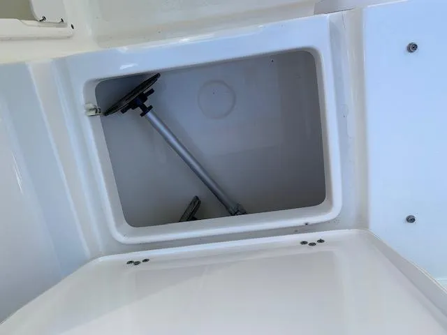 Slide: The Image of Storage compartment of a 2018 Key West 239 DFS boat, featuring a mounted pole. - 6