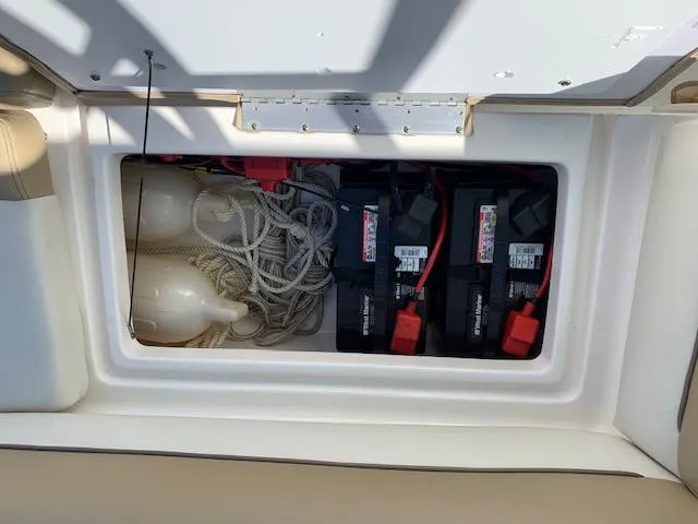 Slide: The Image of 2018 Key West 239 DFS boat storage compartment with batteries and ropes. - 8