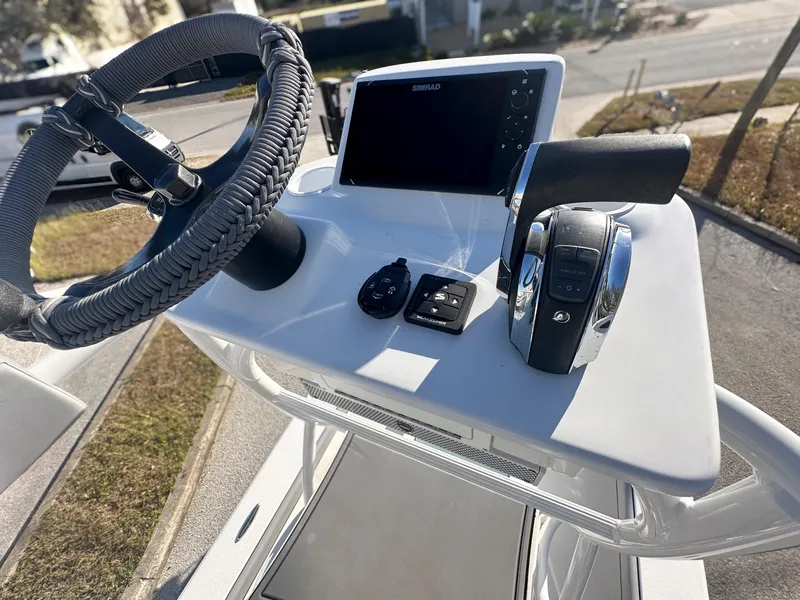 Slide: The Image of Steering console of 2021 Dorado 25 FD boat with modern controls and display. - 15