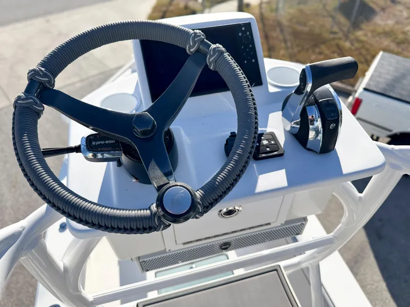 Slide: The Image of 2021 Dorado 25 FD boat helm with steering wheel and controls. - 16