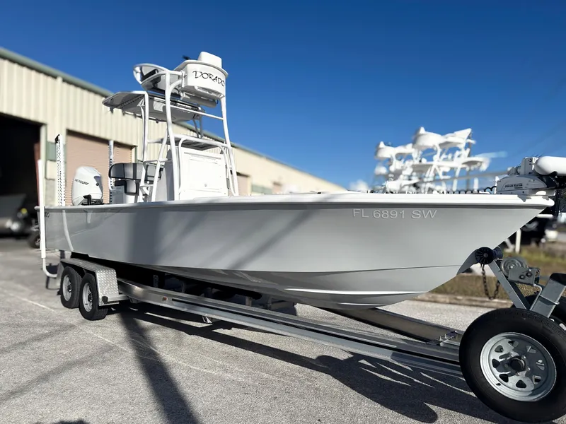 Slide: The Image of 2021 Dorado 25 FD boat on trailer, parked outside a warehouse. - 3